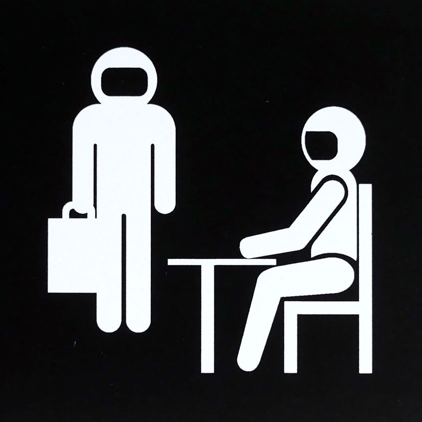 A black and white graphic of office workers wearing space helmets.